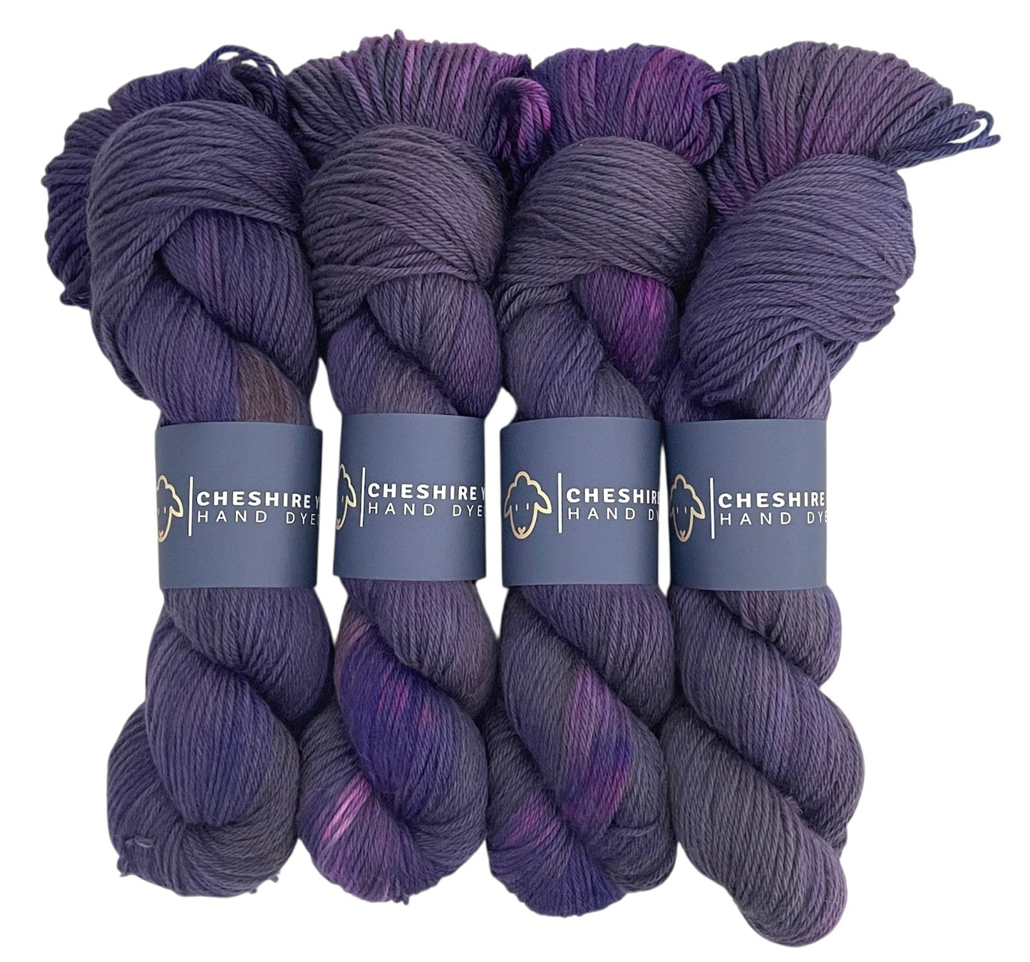 Four skeins of DK non superwash merino and alpaca yarn, hand dyed in shades of purple.