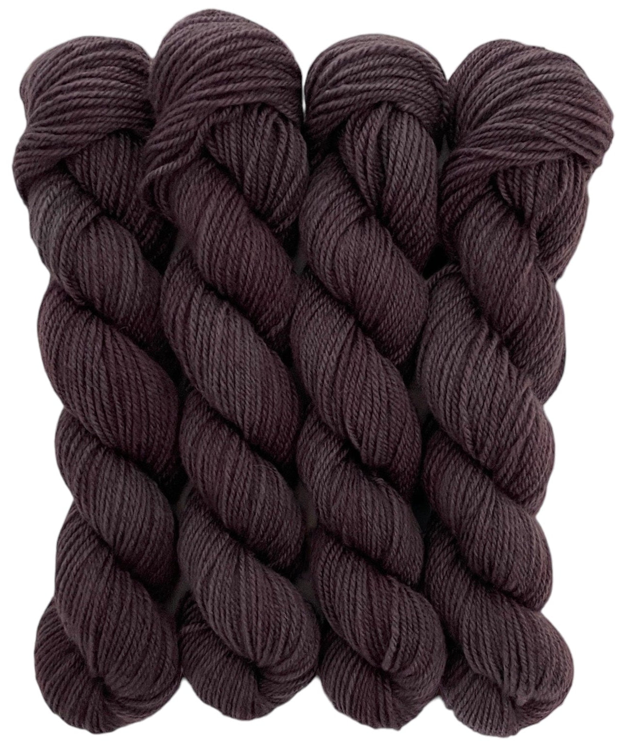 Four skeins of brown merino and blue faced Leicester non-superwash yarn on a white background. Hand dyed. DK