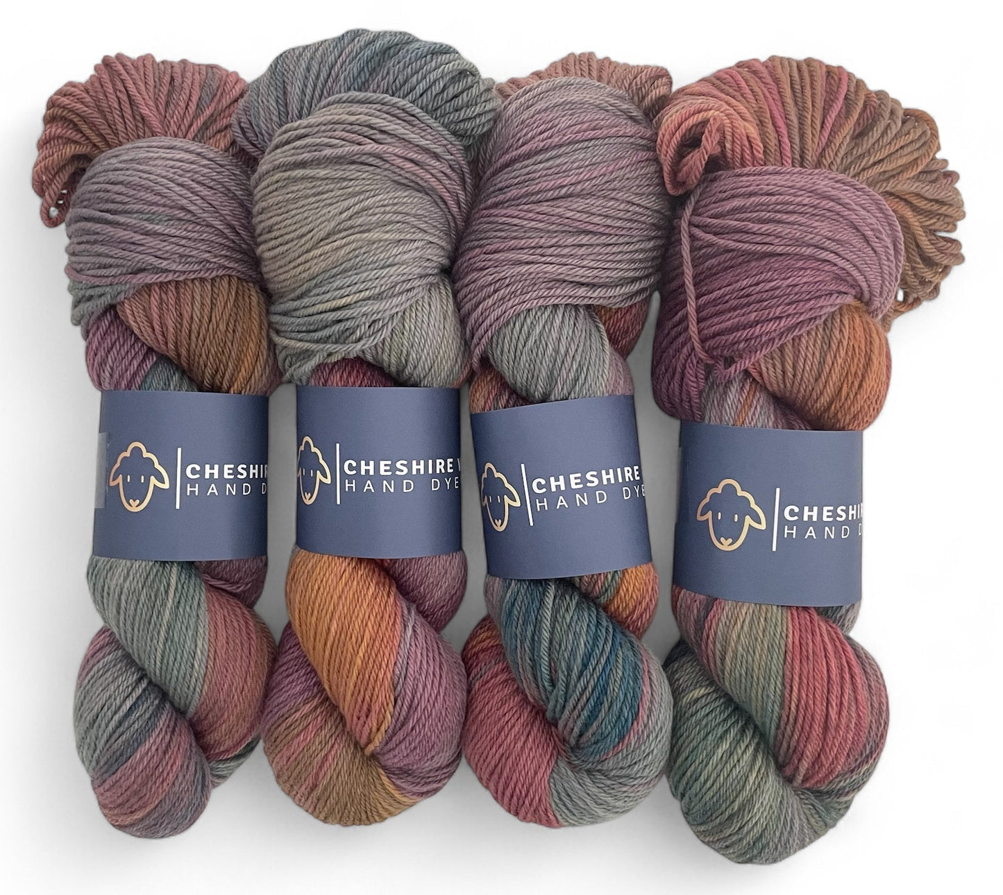 Four skeins of non superwash DK weight sustainable merino wool, hand dyed in shades of brown, grey and green.