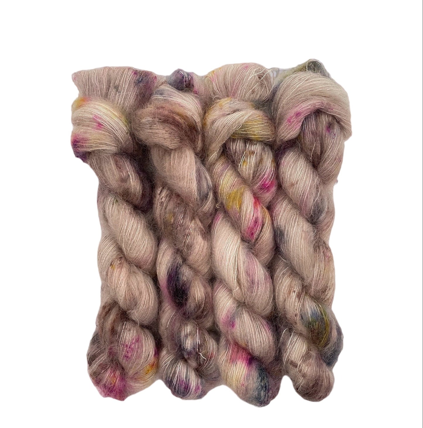 Expertly hand dyed in a delicate blend of kid mohair and silk, BEIGE DAZE brings a touch of luxury to your projects. This lace weight yarn showcases a beautiful beige color with subtle speckles of dark blue and pink, adding a unique and sophisticated touch to any creation.