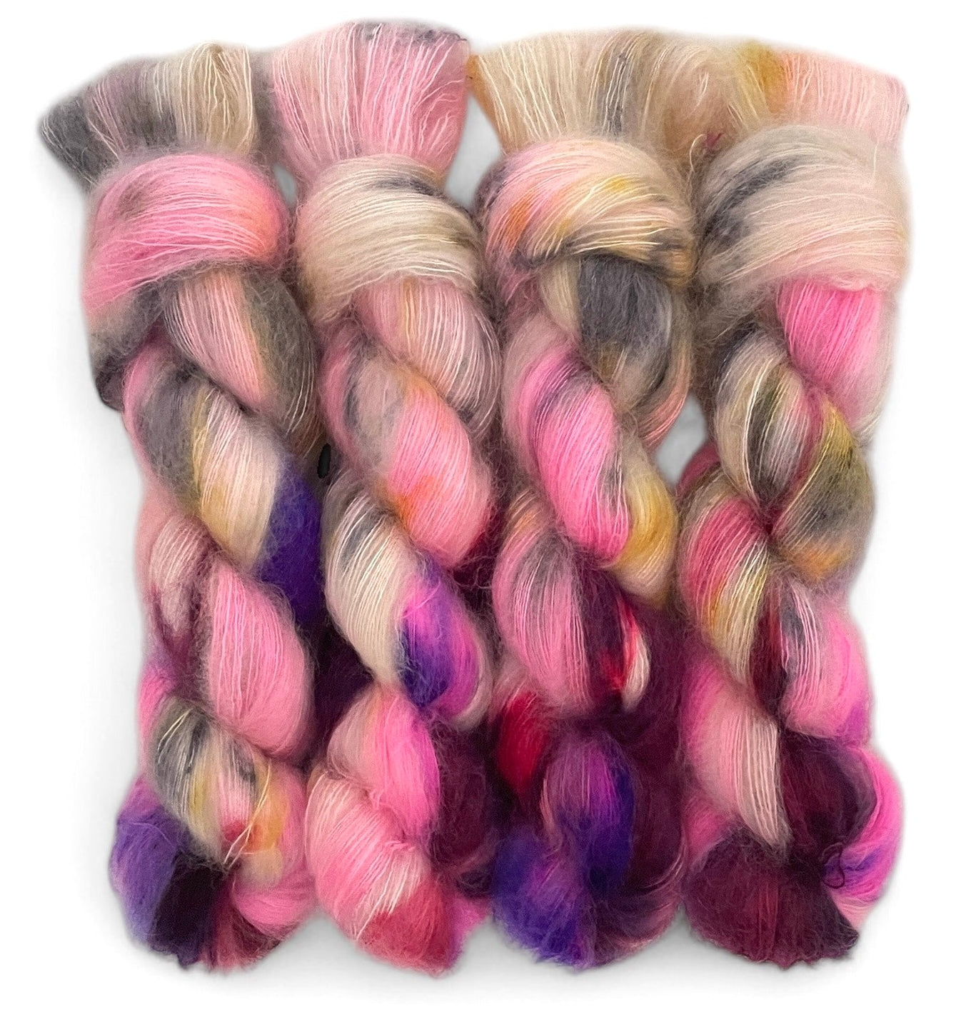 Four skeins of lace weight mohair, hand dyed in shades of pink, purple and grey.