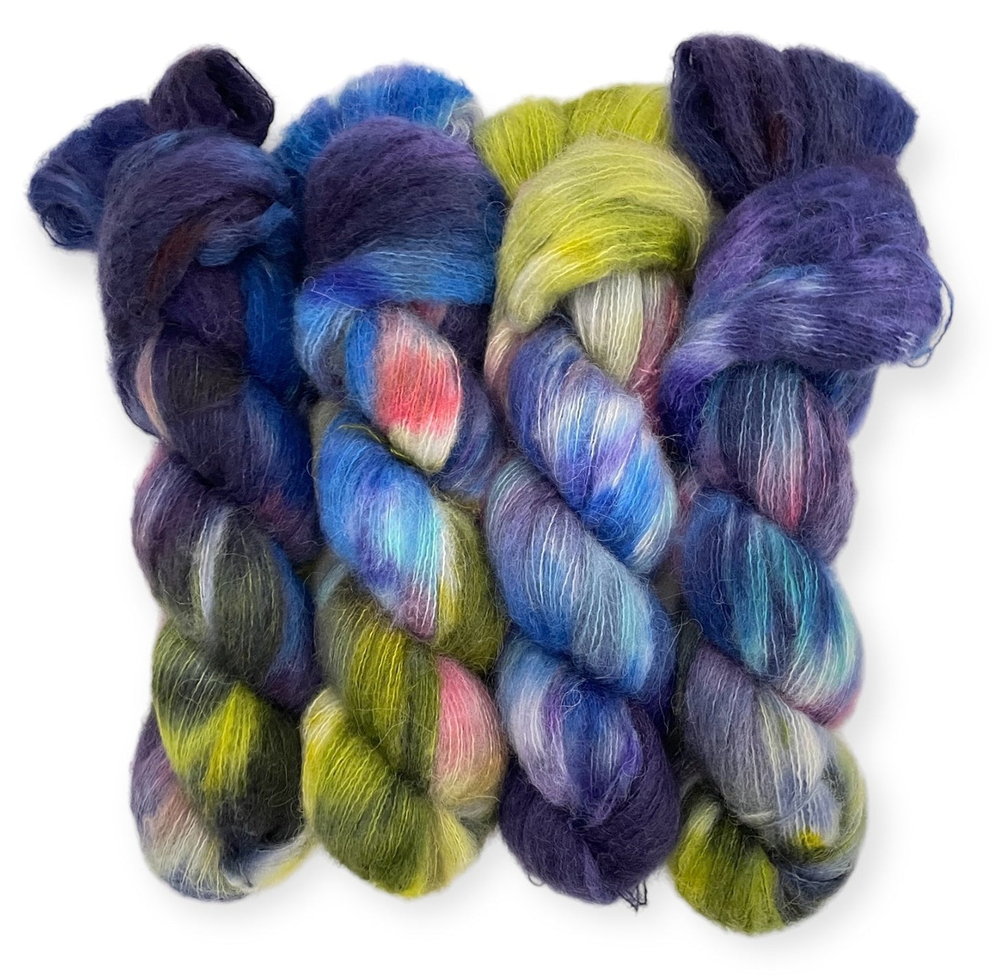 Four skeins of lace weight yarn containing alpaca, silk and cashmere, hand-dyed in a variety of colors including blue, green, yellow, and purple.