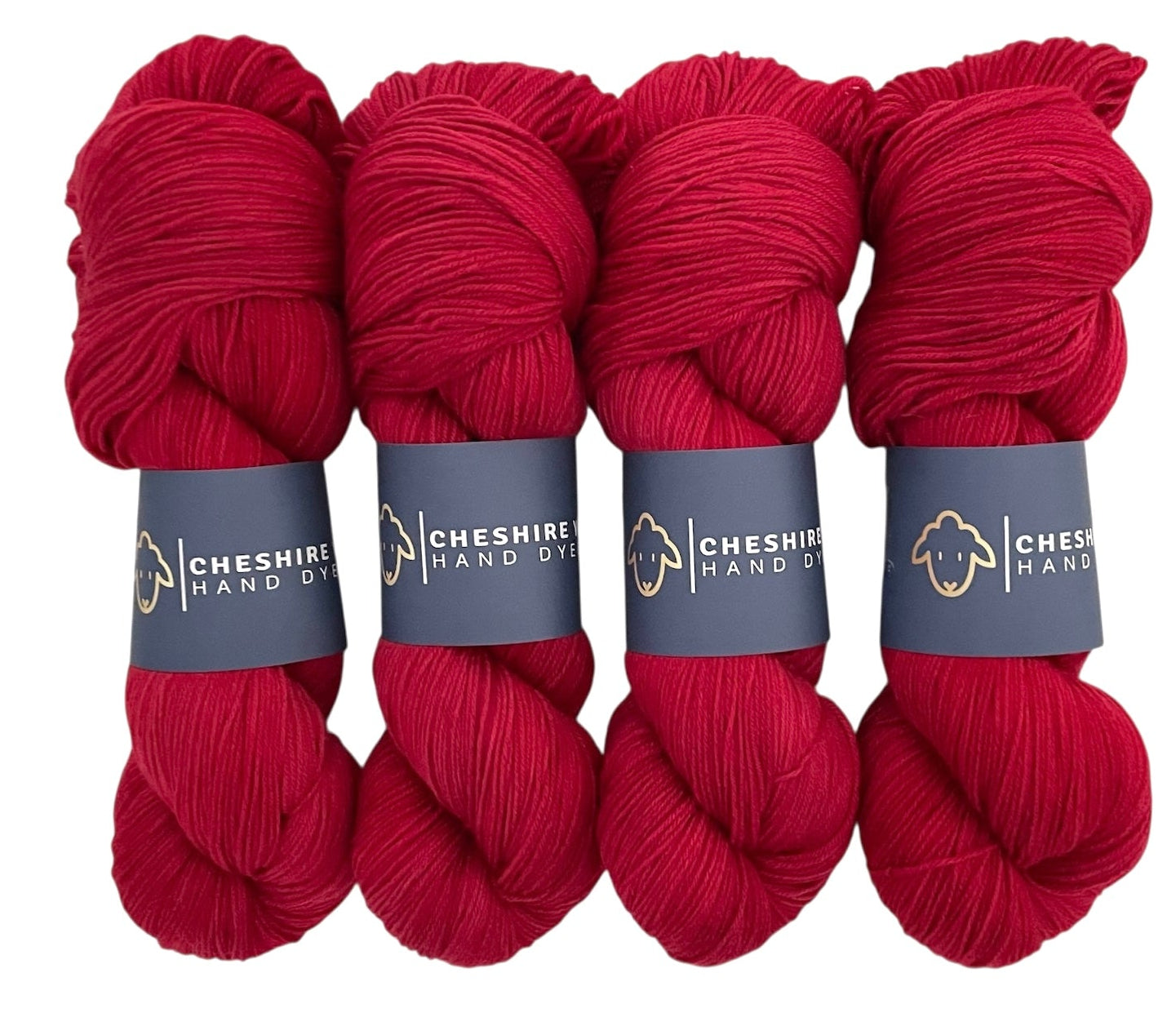 Four skeins of non superwash fingering weight sustainable merino wool, hand dyed red.