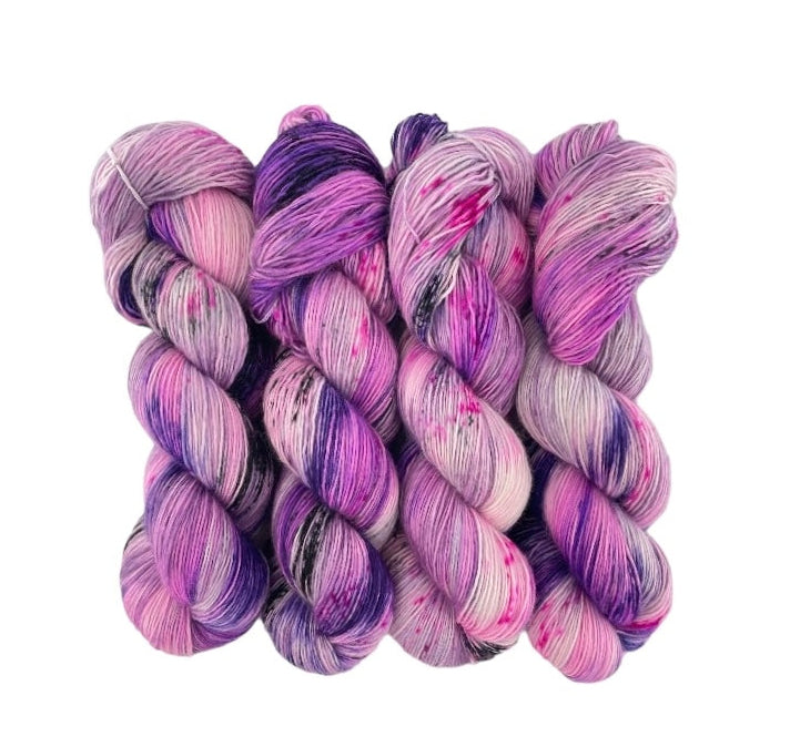 Experience luxury and softness with WILD SIDE - Hand Dyed Yarn. Made from 100% Extrafine Superwash Merino Wool, this single ply yarn is perfect for shawls and sweaters. With its pink base and pops of purple, add a touch of elegance to your projects.