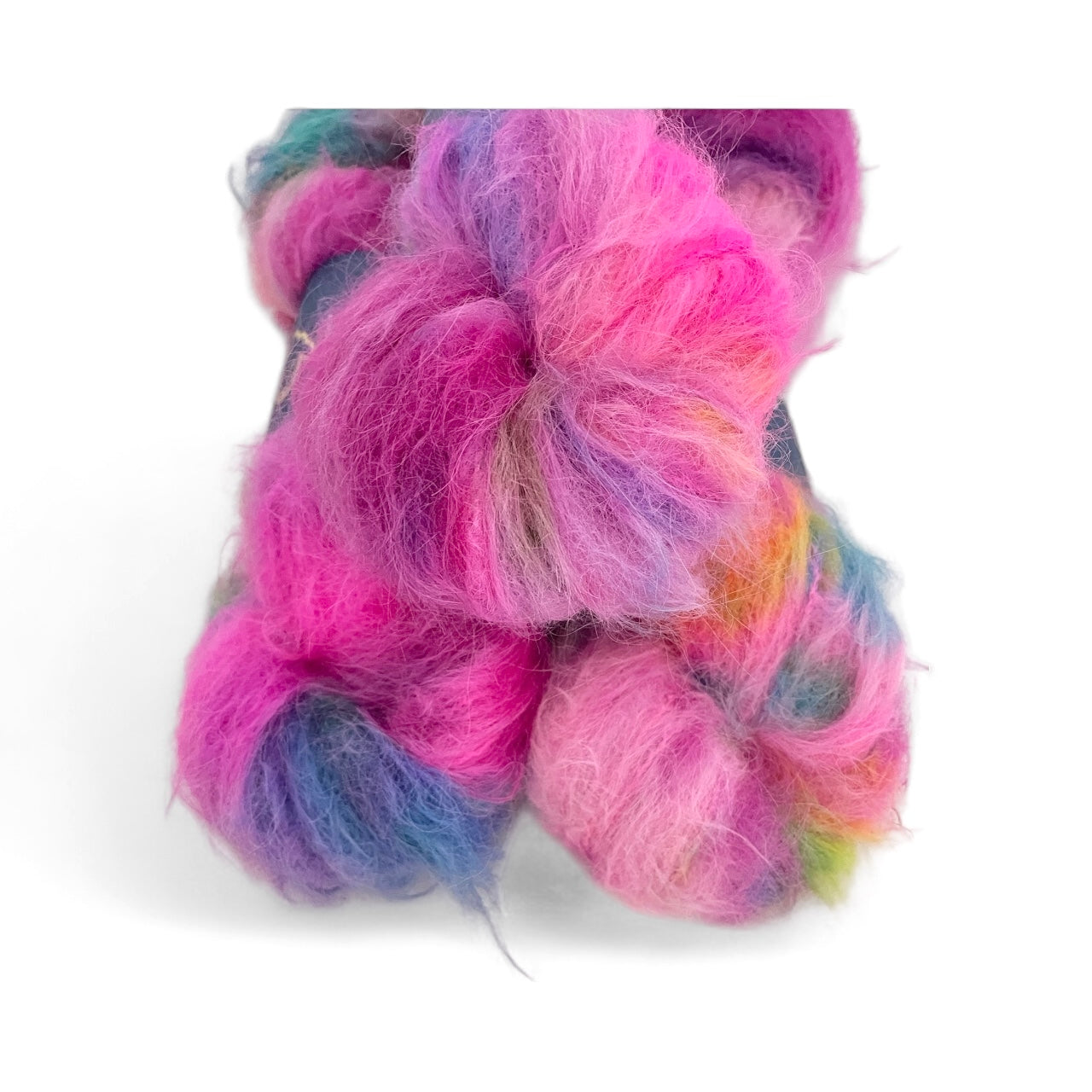 Close up of multi-coloured baby alpaca and merino yarn on a white background