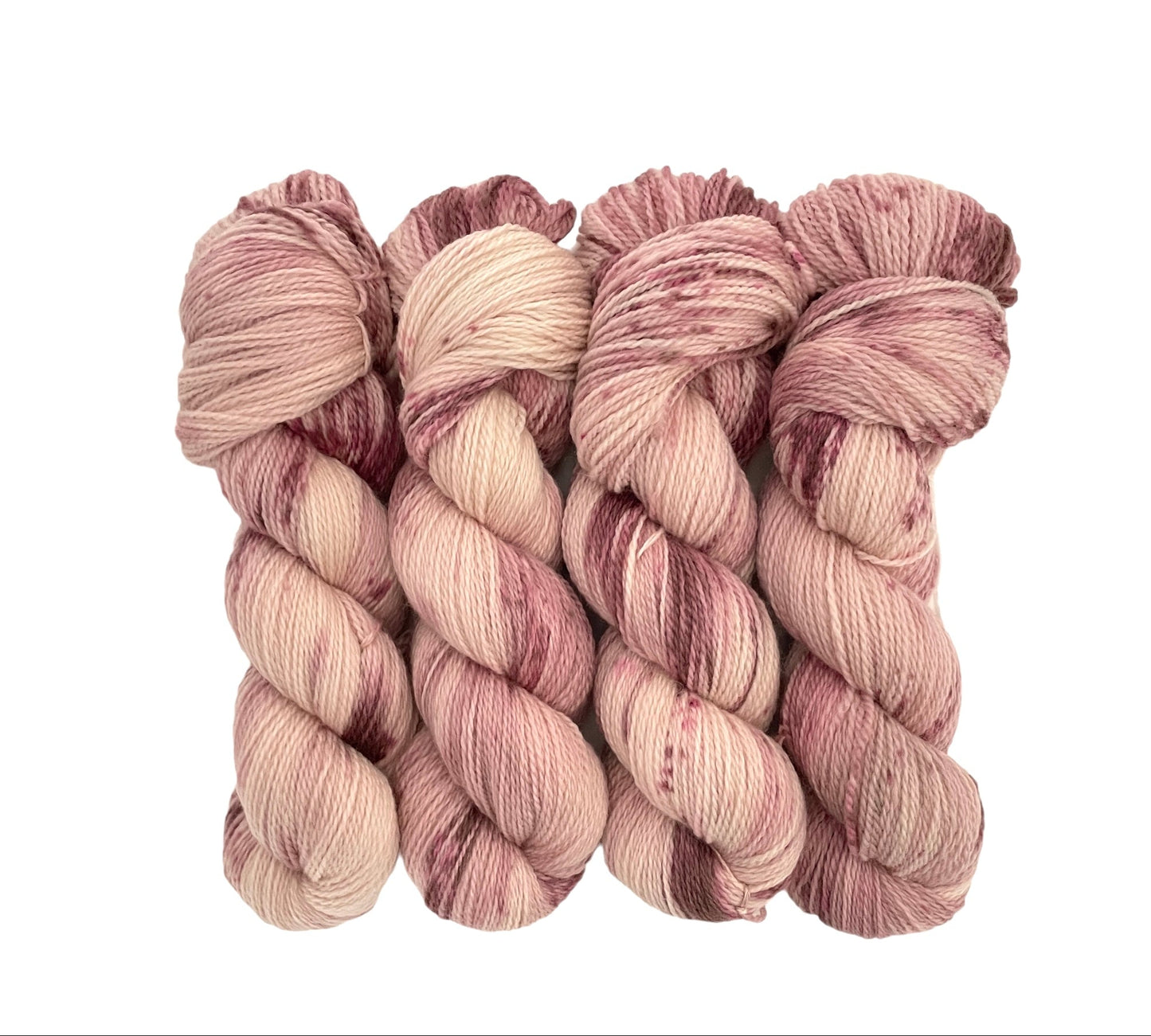 A skein of hand-dyed yarn in shades of pink and brown.