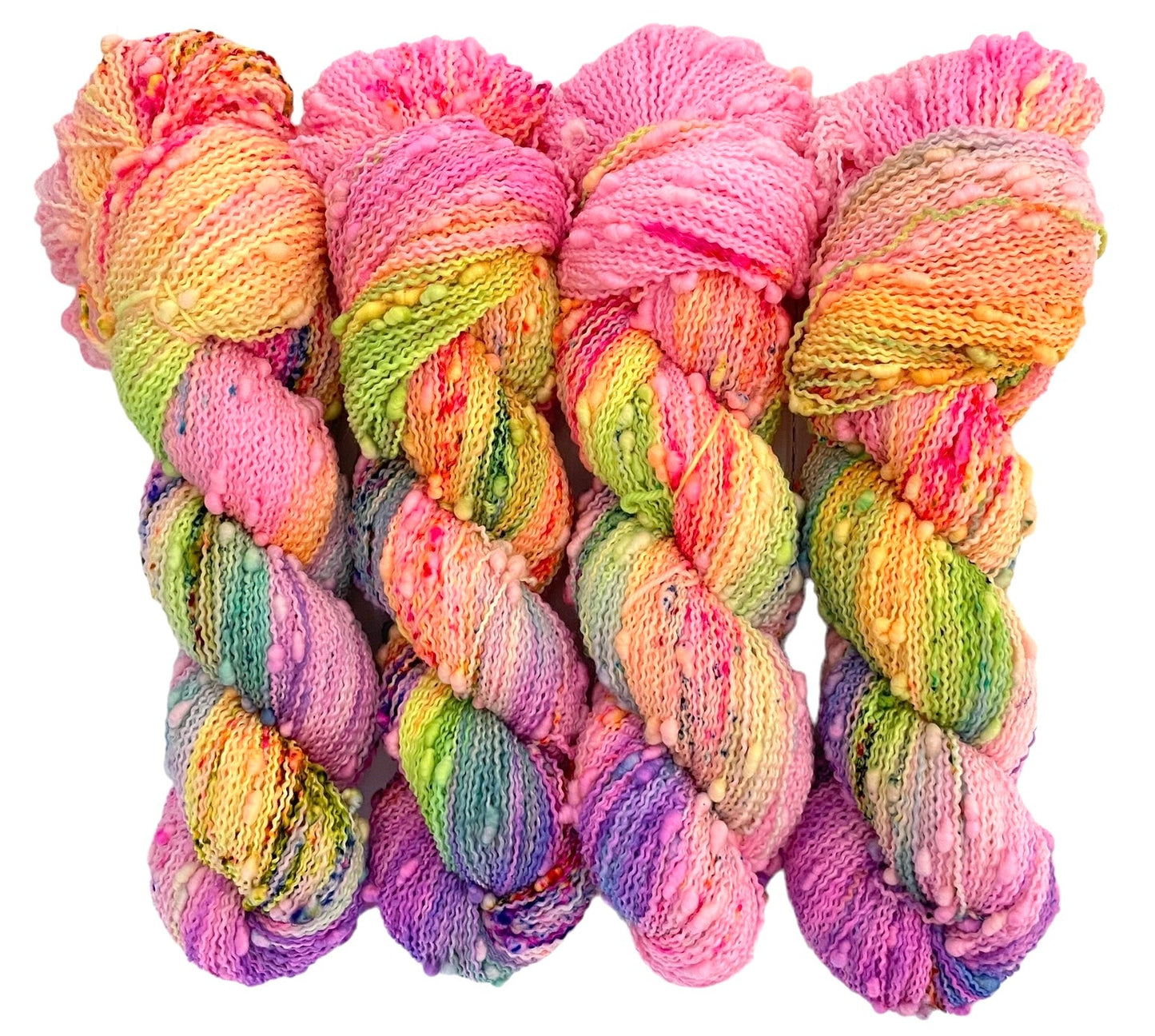 Four skeins of superwash merino slub bobble yarn, hand dyed in pink, orange, purple and green.