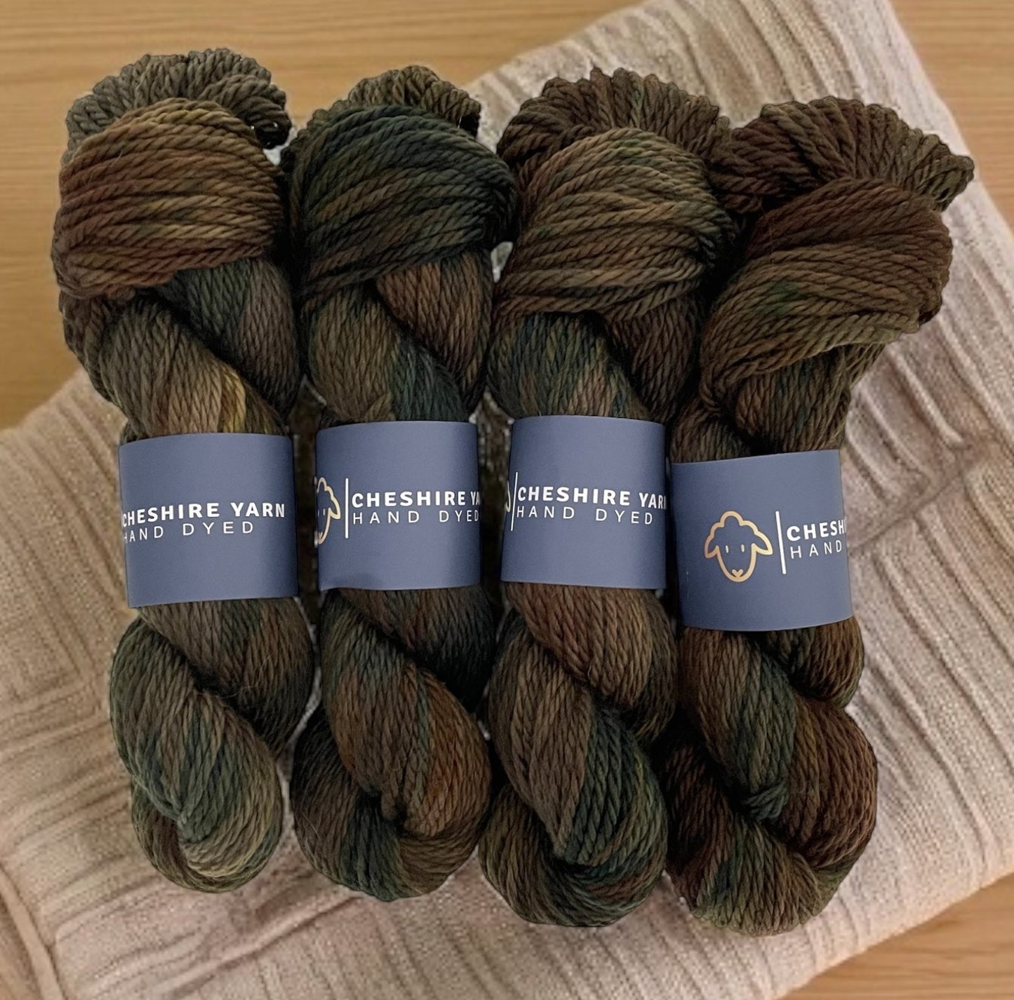 Four skeins of non superwash chunky weight merino wool, hand dyed in earthy brown, green and black.