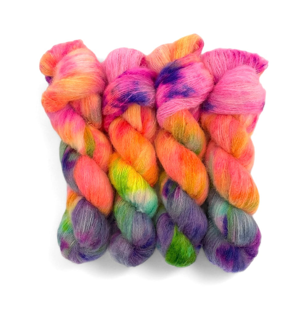 A skein of multicolored hand-dyed lace weight yarn in a rainbow pattern.