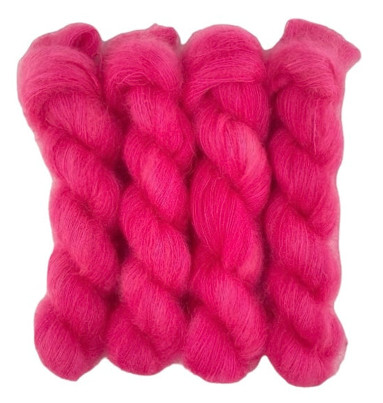 Four bright red hand dyed skeins of lace weight mohair and silk yarn on a white background.