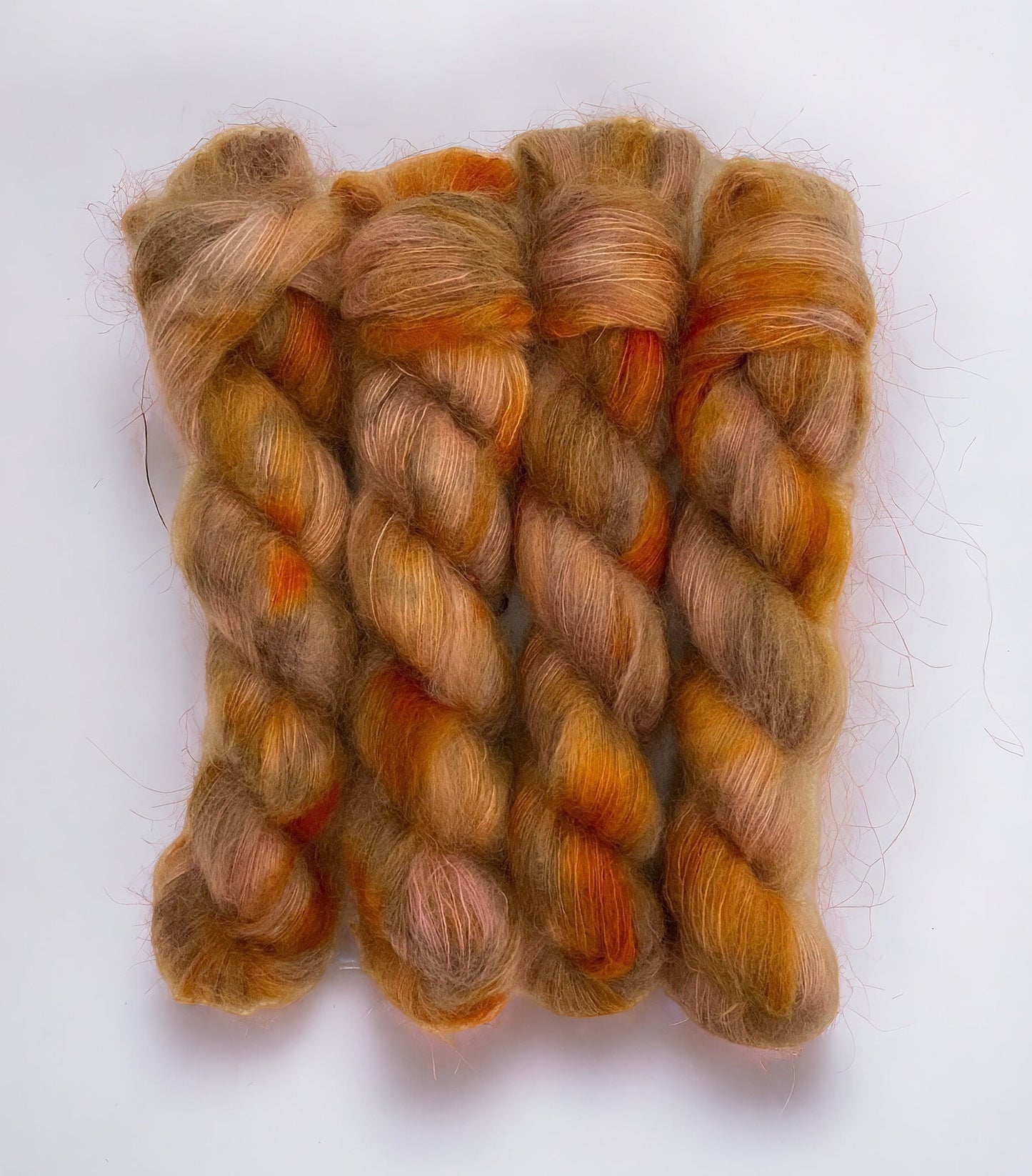 In a delicate lace weight, this 50g skein offers a perfect blend of softness and strength. The rich copper colors add a touch of glamour to your knitting projects.