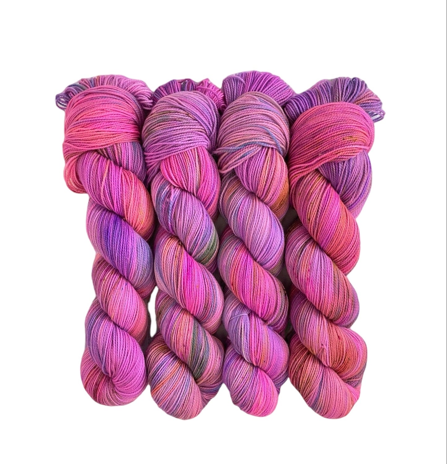 Hand dyed, this fingering/sock weight yarn is made from a luxurious blend of merino wool and nylon. With shades of pink, orange, and purple, each 100g skein is uniquely vibrant and soft to the touch. Perfect for creating long-lasting, colorful projects.