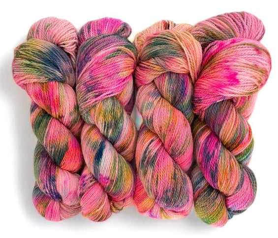 Four skeins of non superwash fingering weight peruvian highland wool, hand dyed in various colours including pink, yellow, orange and green.