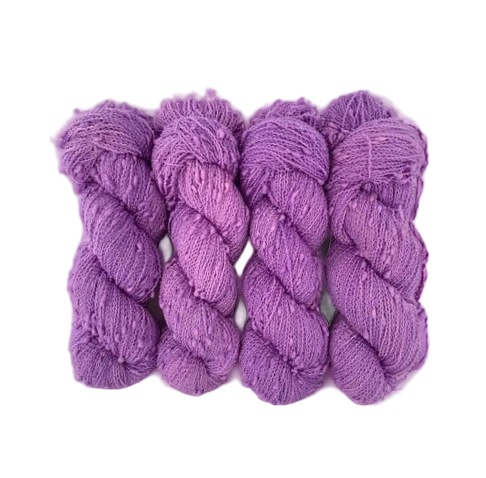 HYDRANGEA yarn offers a unique blend of merino and nylon for added durability. The textured slub design in pink/purple adds depth and dimension to any project. Each 100g skein is perfect for lightweight, yet sturdy, fingering weight projects.