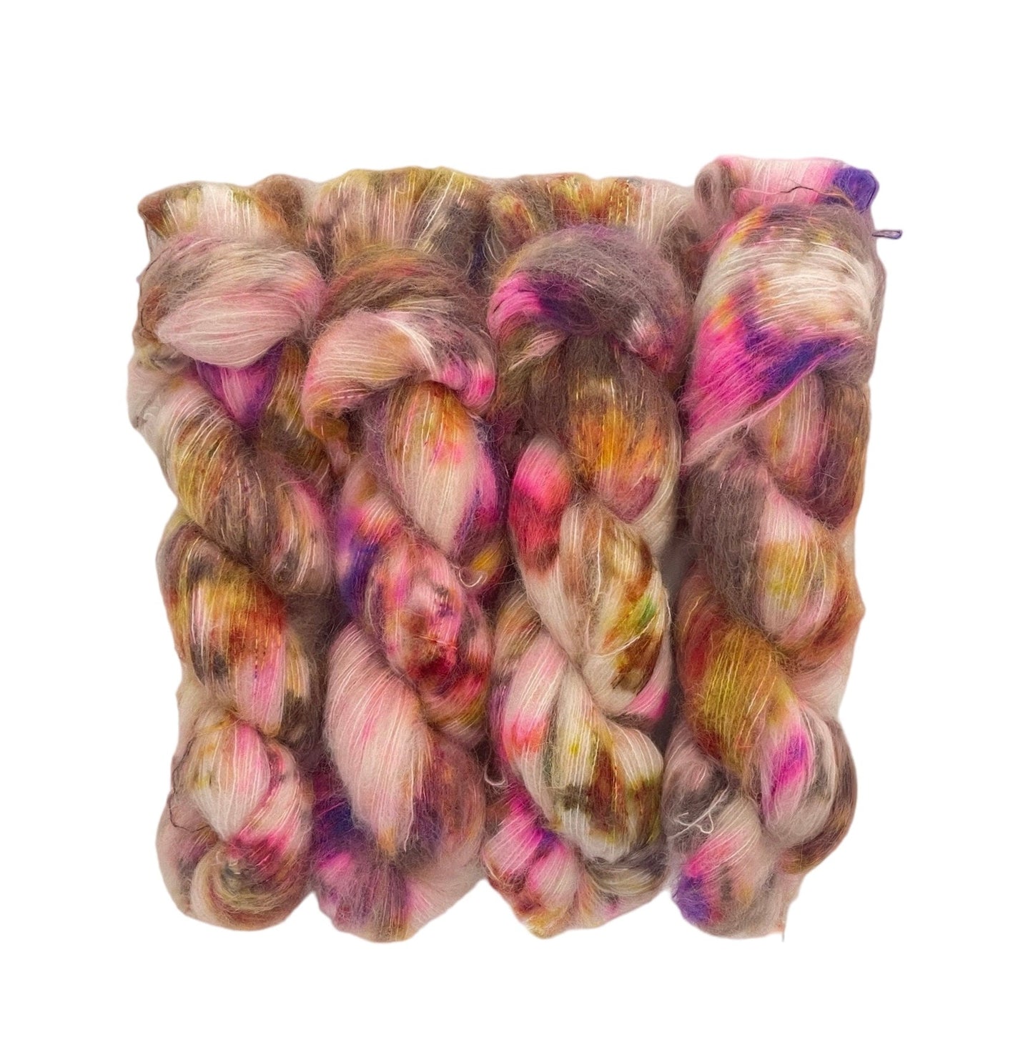 Indulge in luxury with COCOA DRIZZLE, a hand-dyed yarn made from baby suri alpaca and mulberry silk. Perfect for knitting and weaving, this lace weight yarn boasts a cream-colored base with pops of brown, pink, and green. Elevate your projects with this high-quality, mixed color skein.