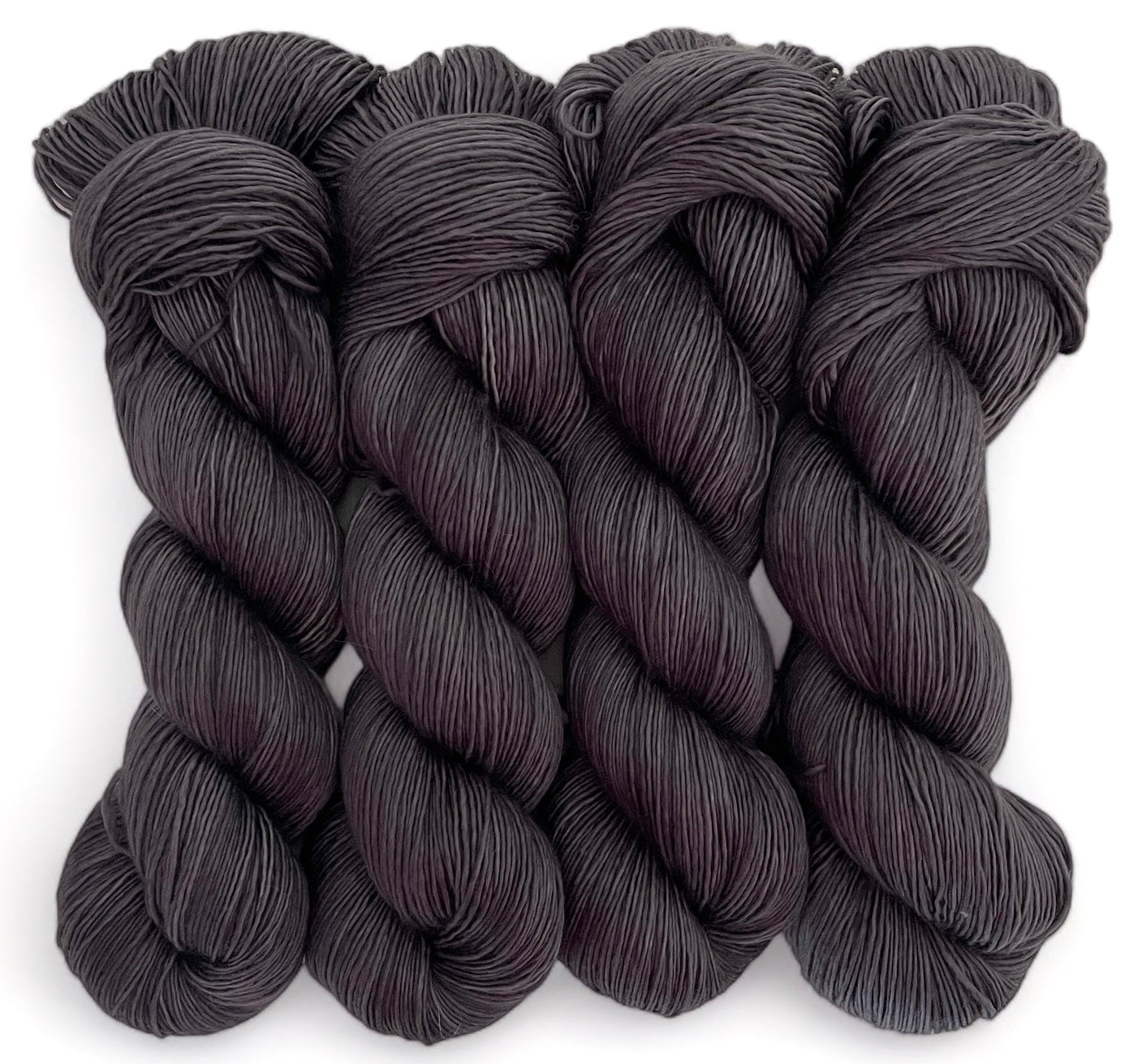 Four skeins of extrafine superwash sock weight merino wool, hand dyed brown.