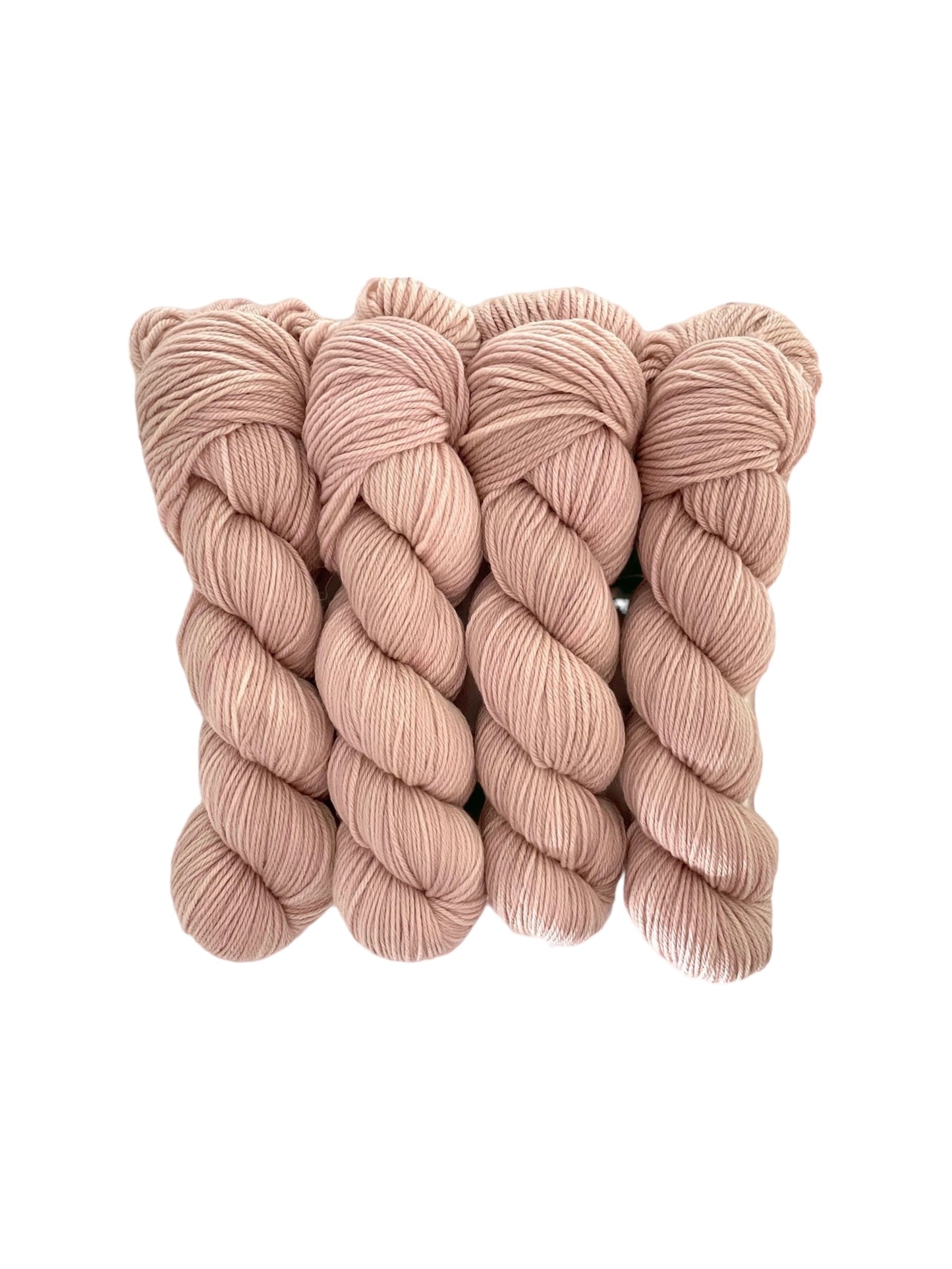 Made from 100% organic merino wool, our hand-dyed base of dusty pink offers a luxurious and eco-friendly choice for your wardrobe.