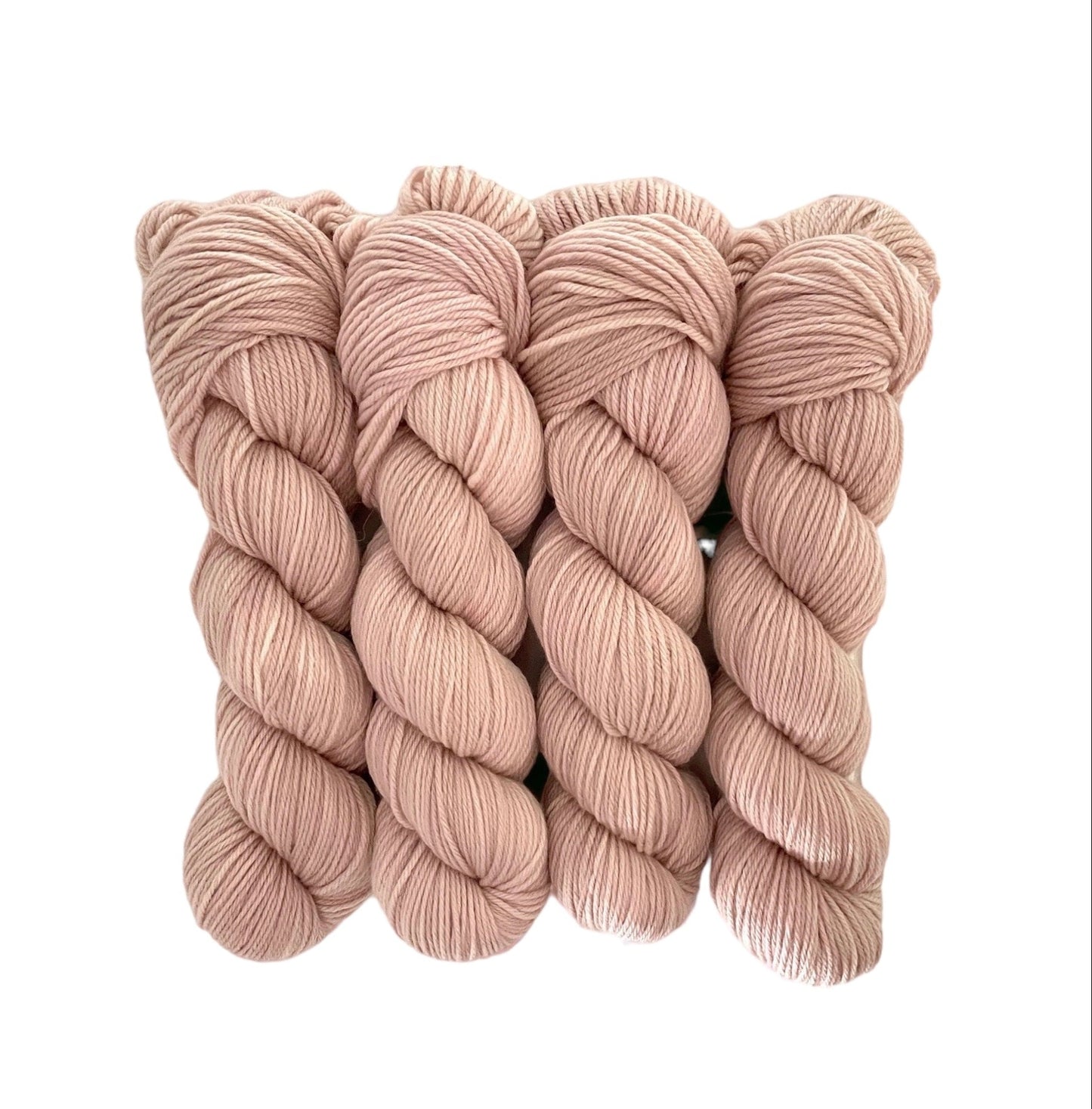 Made from 100% organic merino wool, our hand-dyed base of dusty pink offers a luxurious and eco-friendly choice for your wardrobe.