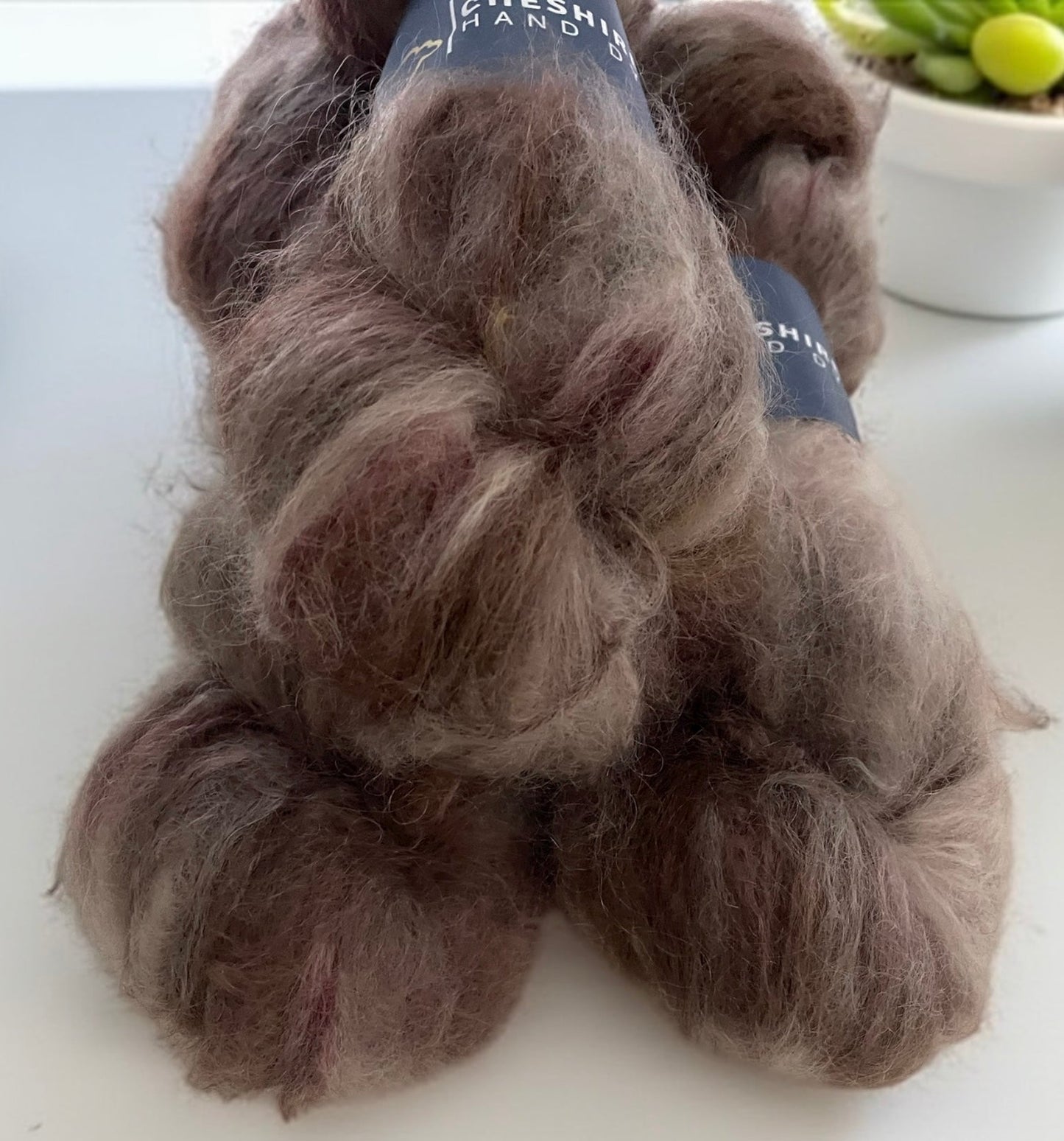 Three skeins of DK weight mohair yarn, hand dyed in shades of brown.