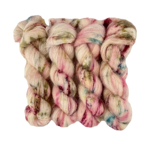 Beautifully soft and light as air, this luxurious blend of Suri Alpaca and silk is a delight to wear against the skin. Can be used on its own (held single or double) or in combination with other yarns to add fluffy texture to your projects. A perfect substitute for those sensitive to mohair. Pinks & greens on a cream base.