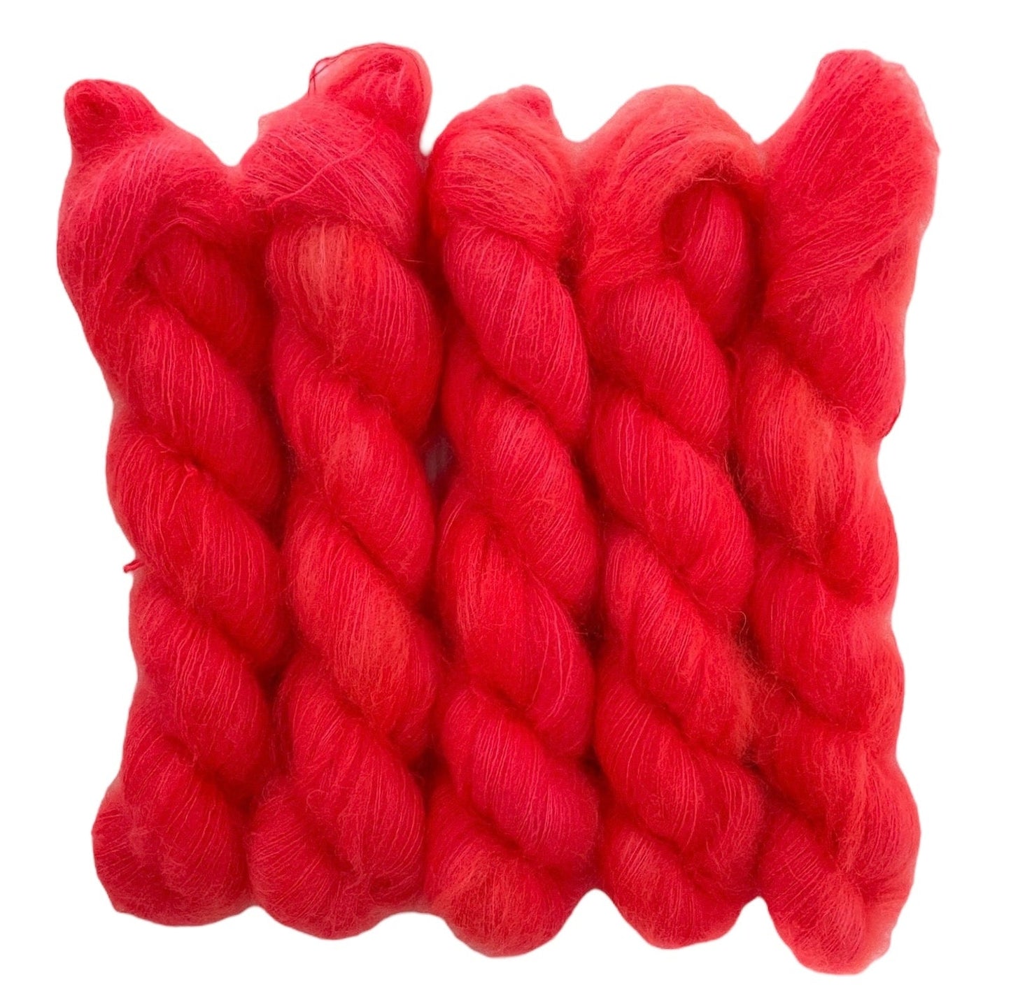 Five red hand dyed skeins of lace weight mohair and silk yarn on a white background.