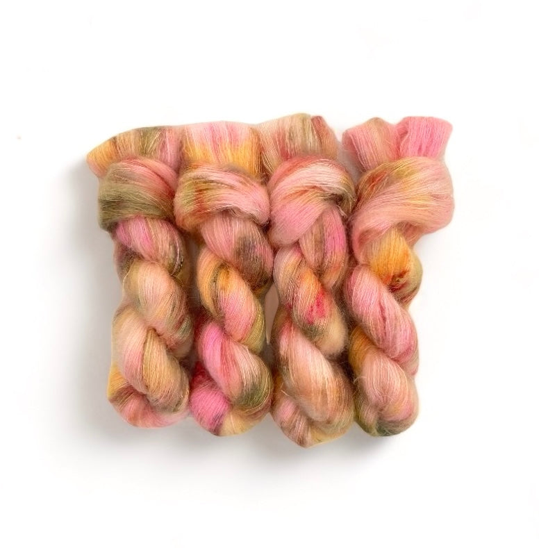 Introducing CROCUS TINT a luxurious hand-dyed yarn made with a blend of soft Superkid Mohair and Silk. Each 50g skein features beautiful shades of yellow, pink & green. Perfect for creating delicate and elegant lace projects. 