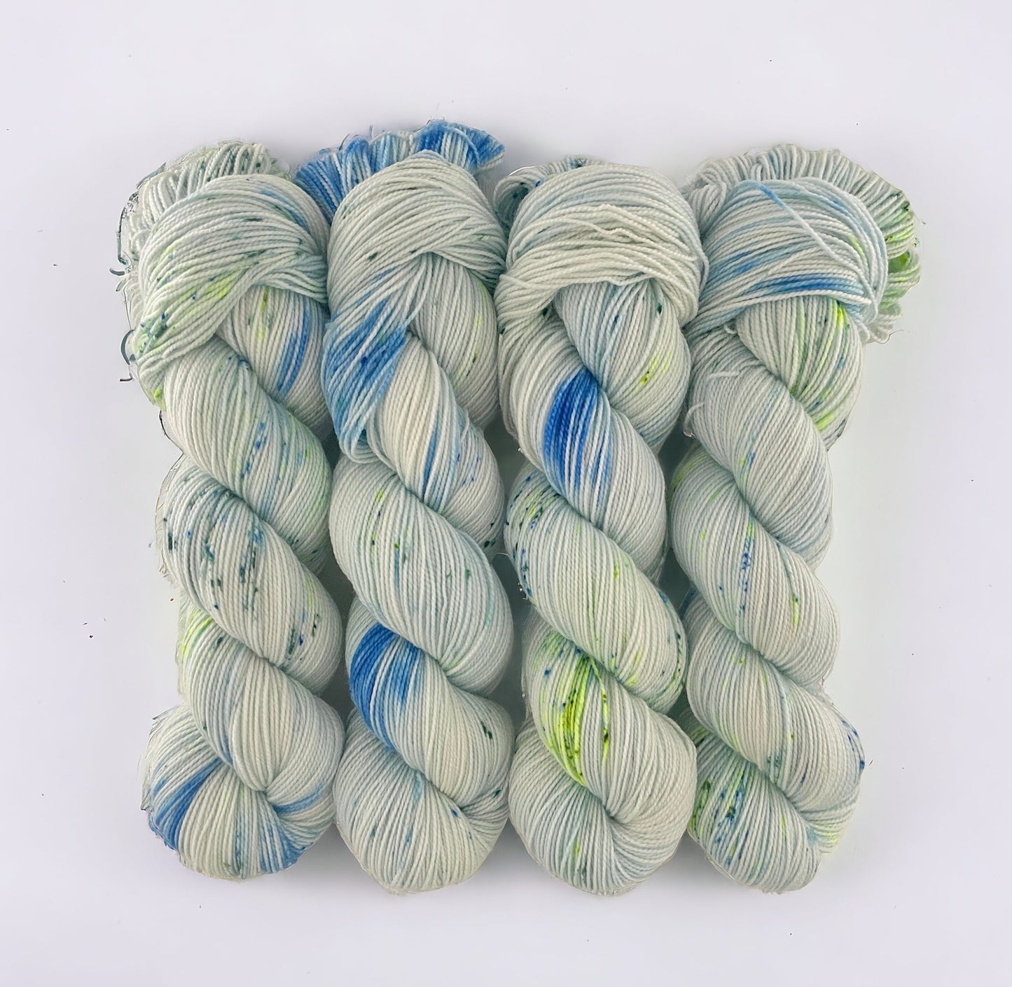 Made from a blend of Merino Wool and Nylon, this Fingering/Sock Weight Yarn is perfect for all your knitting & crochet projects. The pale blue base is elevated with splashes of green & blue, adding a unique touch to your designs.