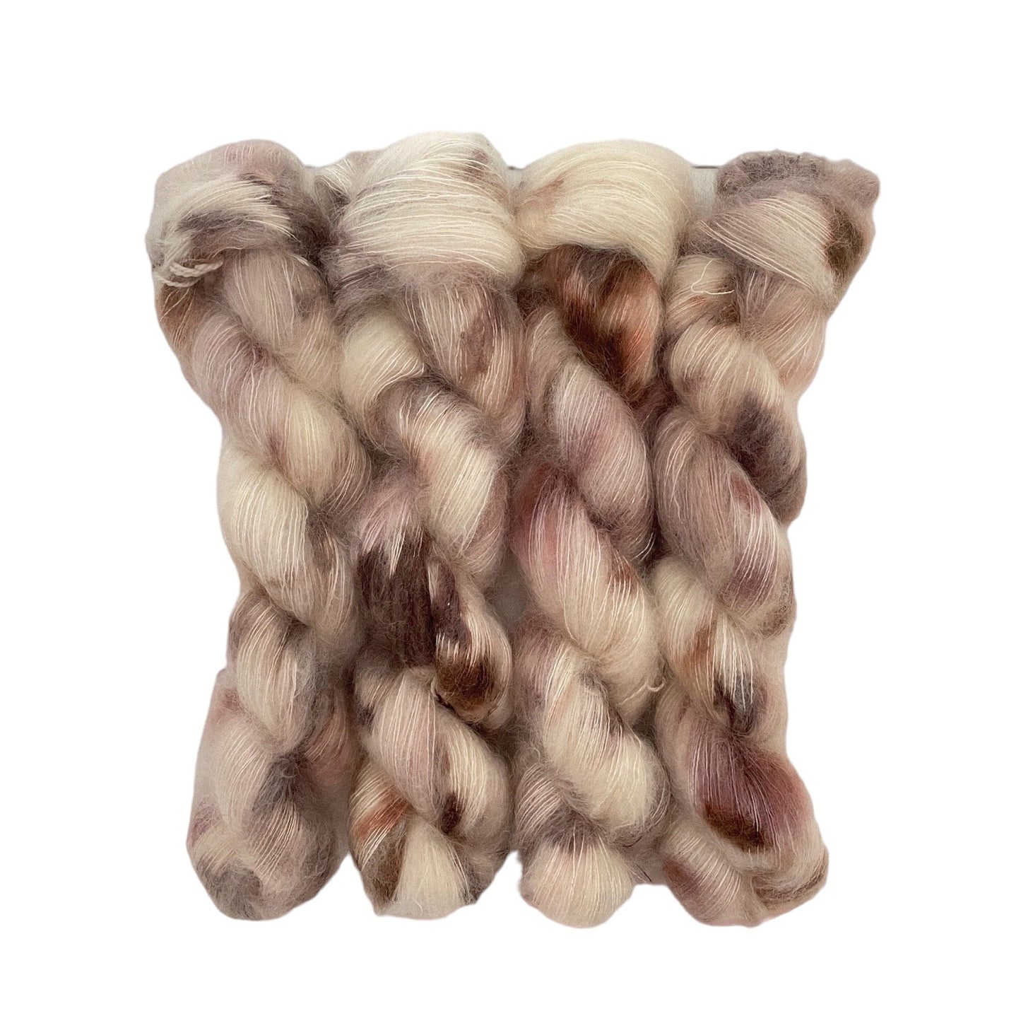 This luxurious COCONUT LATTE is handcrafted with a blend of hand dyed kid mohair and mulberry silk, resulting in a creamy texture with shades of brown and beige. The delicate materials provide a soft and gentle touch, while the rich colors add a touch of elegance.