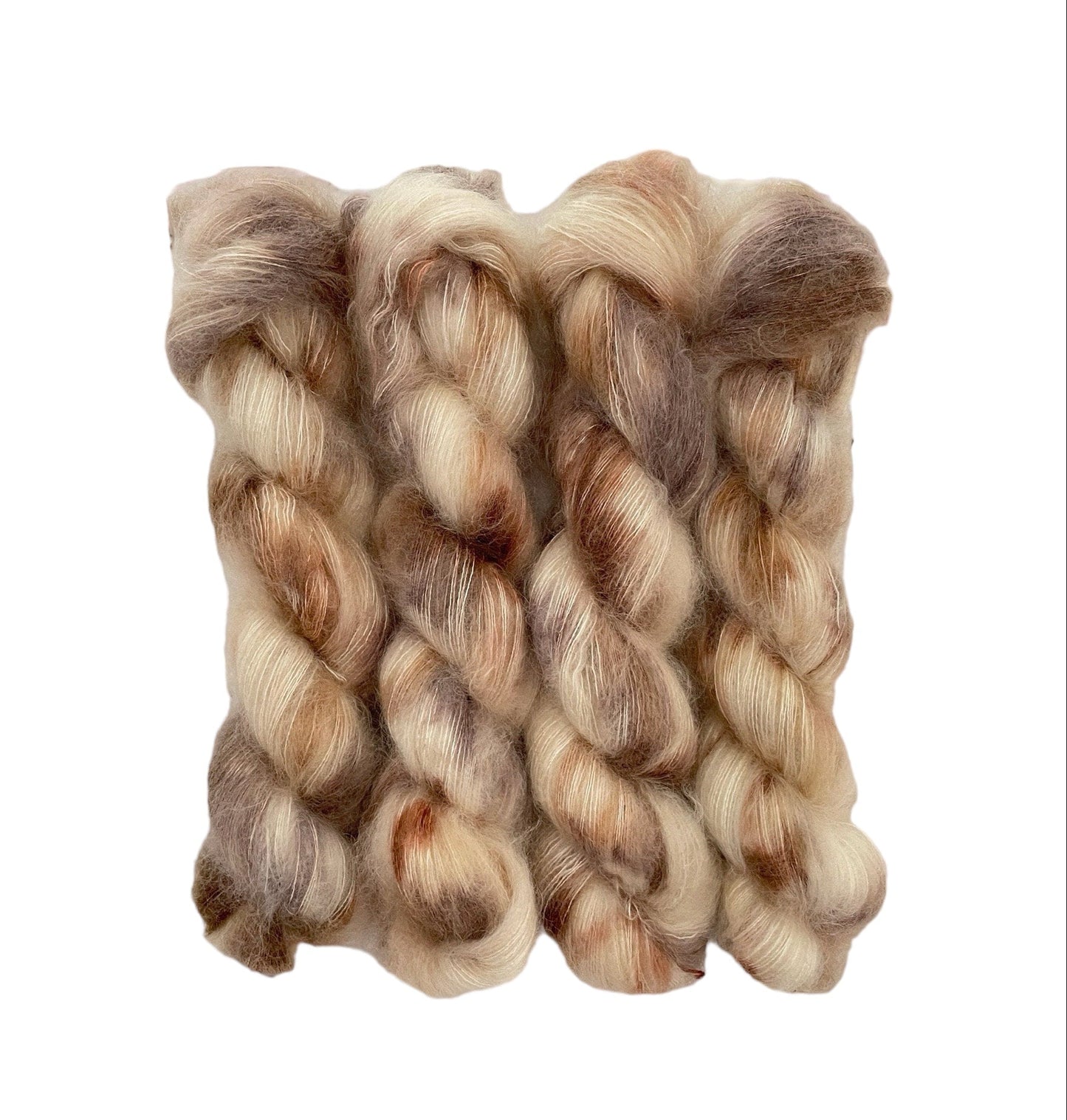 Experience the luxurious blend of kid mohair and silk with TATTERED TEDDY hand dyed yarn. The cream base is intricately dyed with beige & brown, creating a unique and stunning color combination. Perfect for delicate and lightweight lace projects.