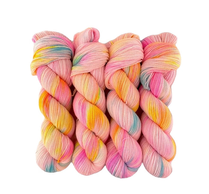 A skein of multicolored hand-dyed yarn made of 100% merino wool.