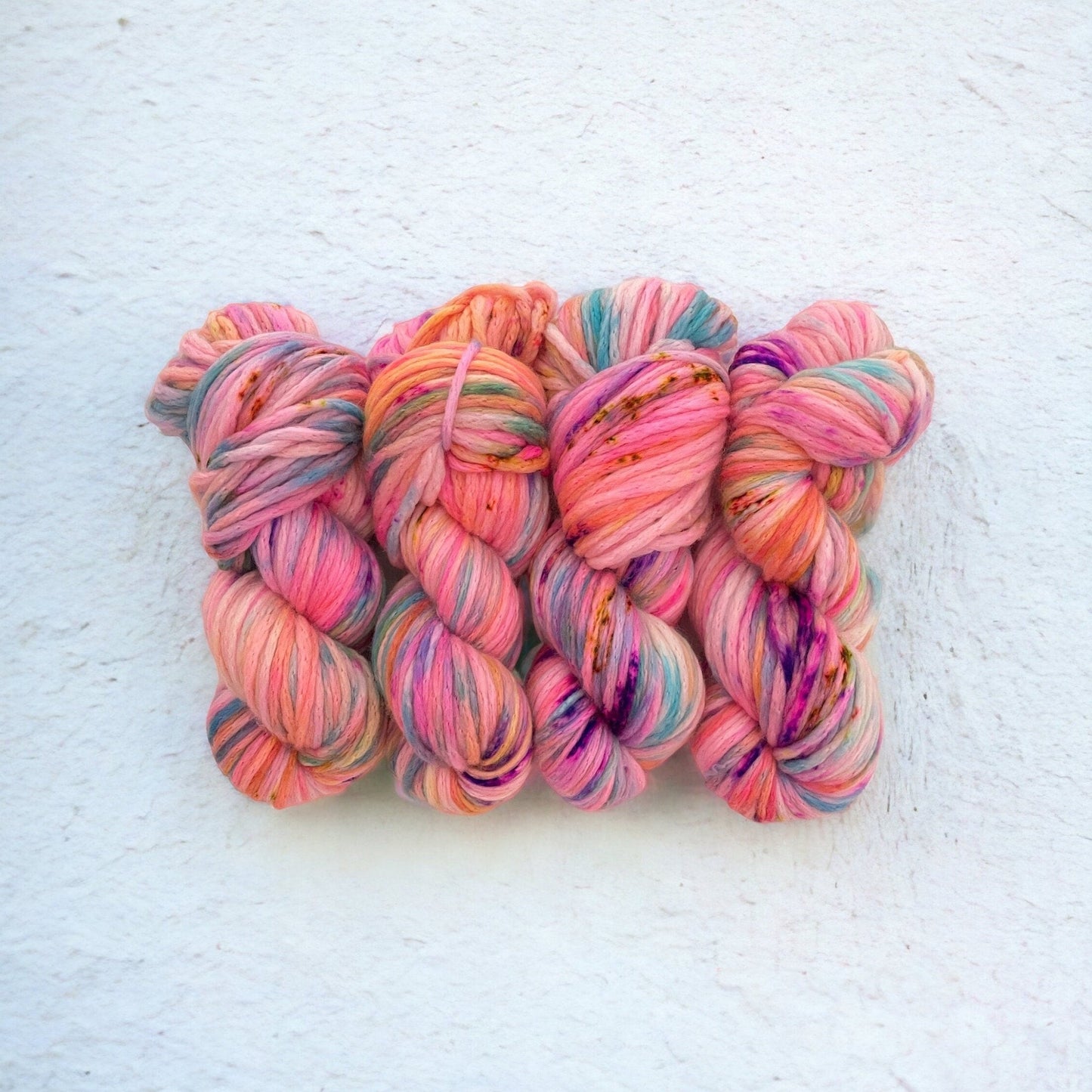 Our ONE OF A KIND yarn is a vibrant blend of pink, orange, blue & purple. Made with super chunky fibers, it creates beautiful texture and warmth in any project.