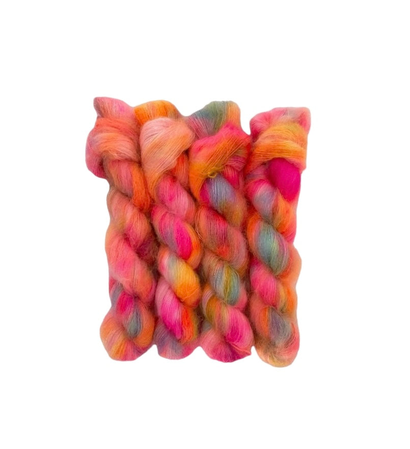 Hand-dyed in bright shades of orange and pink, BRIGHT P.J.s Hand Dyed Yarn is made of luxurious kid mohair and silk blend, perfect for lace weight projects. Each 50g skein offers a vibrant color and soft, delicate texture for stunning results. 