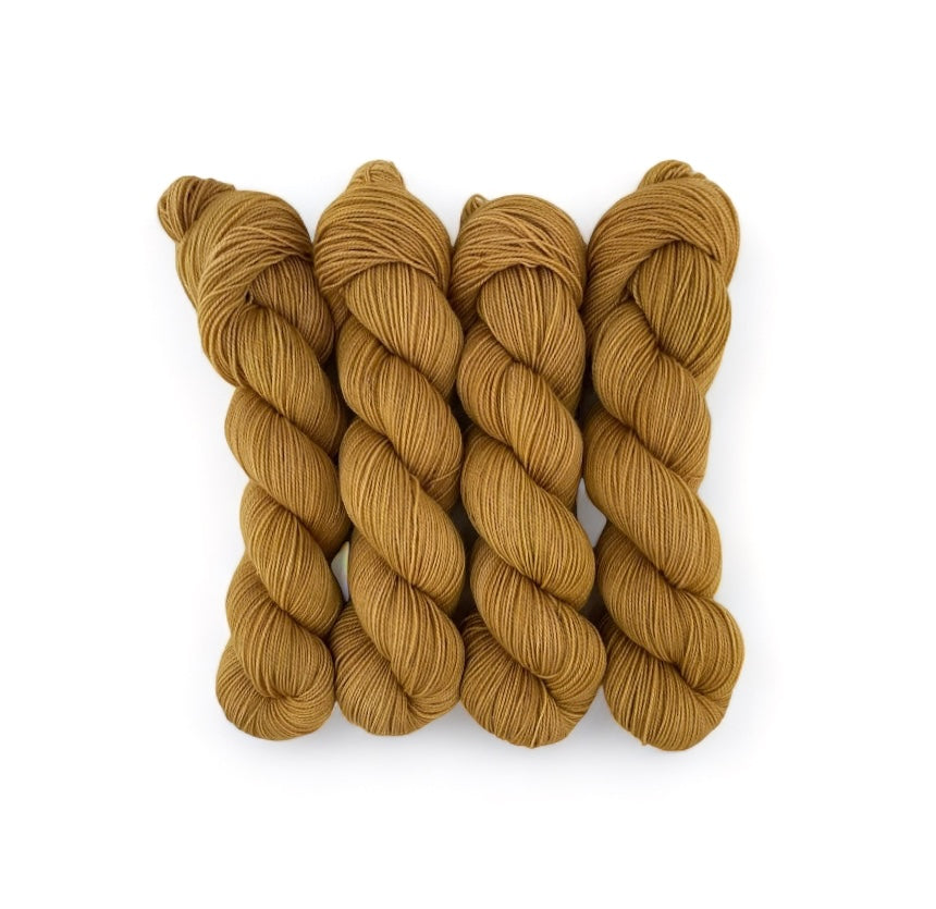 Expertly hand-dyed using premium British Blue Faced Leicester wool and nylon blend, SPICE COOKIE yarn boasts a vibrant gold colour. This fingering/sock weight yarn is perfect for crafting durable and stylish accessories with a soft touch.