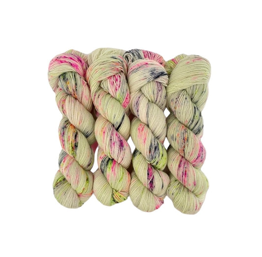 Experience the ultimate in softness and durability with our COOL SUMMER Hand Dyed Yarn. Made from a blend of Merino Wool and Nylon, this Fingering/Sock Weight Yarn is perfect for all your knitting & crochet projects. The pale green base is elevated with splashes of pink, orange, and black, adding a unique touch to your designs.