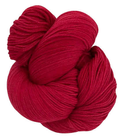 Skein of non superwash fingering weight sustainable merino wool, hand dyed red.
