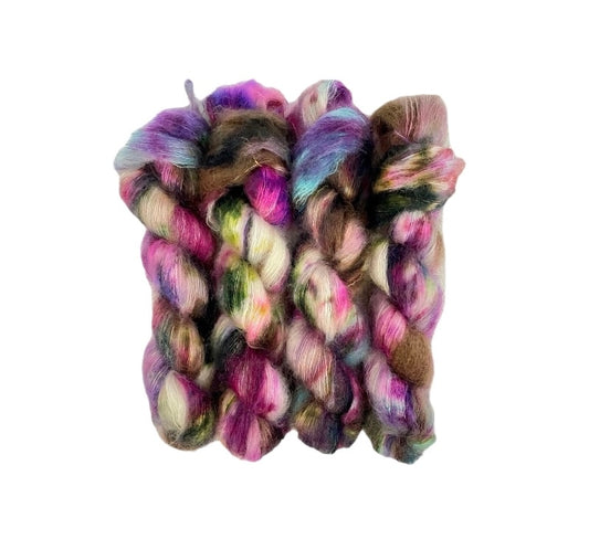 DAPPER hand-dyed yarn is a blend of kid mohair and silk, creating a soft and lightweight texture. The beautiful colors of white, pink, brown & blue will add a unique touch to your knitting projects. Each 50g skein is carefully crafted for a truly one-of-a-kind piece.