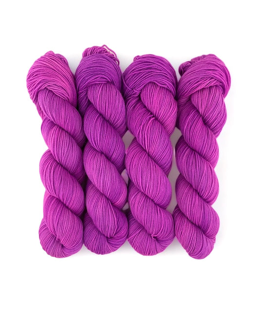 Expertly hand-dyed using premium British Blue Faced Leicester wool and nylon blend ,POPPING yarn boasts a vibrant Purple design. This fingering/sock weight yarn is perfect for crafting durable and stylish accessories with a soft touch.