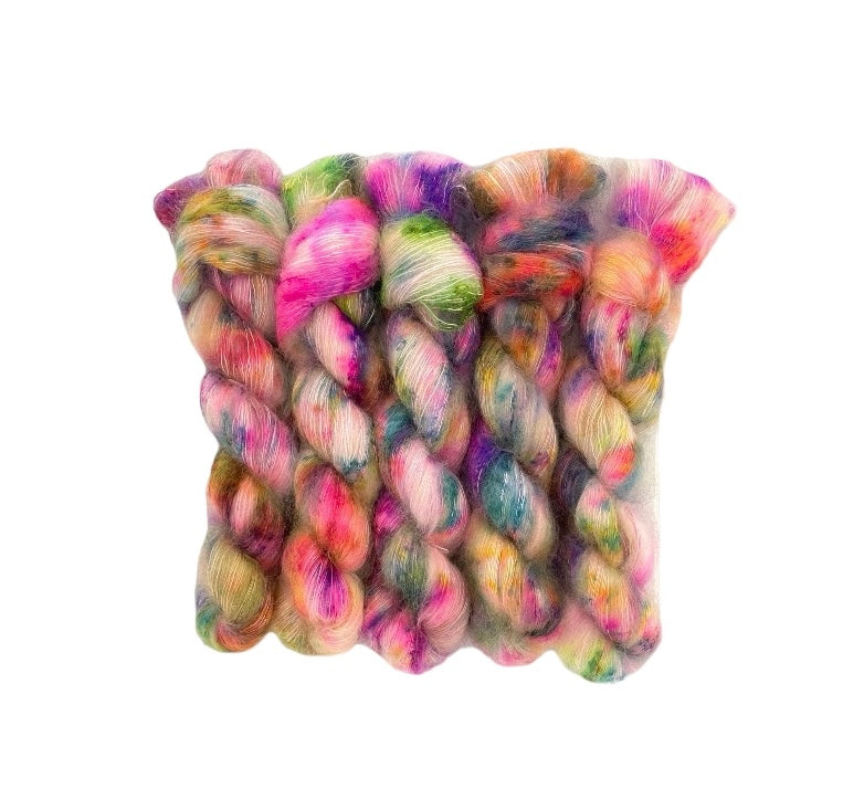 This 50g skein of GARDEN PARTY hand-dyed yarn features a luxurious blend of kid mohair and silk in a lace weight, creating a multi-colored masterpiece. Elevate your knitting or crochet projects with the unique and vibrant colors of this premium yarn. Perfect for adding texture and dimension to any project.