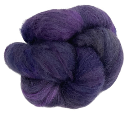Skein of lace weight suri alpaca yarn, hand dyed in shades of purple.