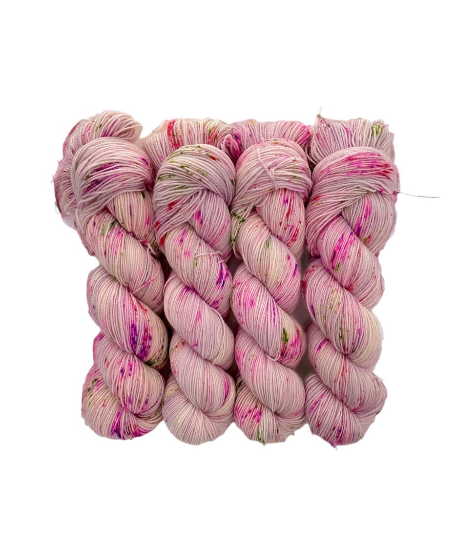 FAIRY DUST yarn is made from 80% Superwash British Blue Faced Leicester wool for a soft, luxurious feel. The addition of 20% nylon adds durability and strength, making it perfect for socks and other projects. Available in a 100g skein in a beautiful palette of pink, lilac, white & green.