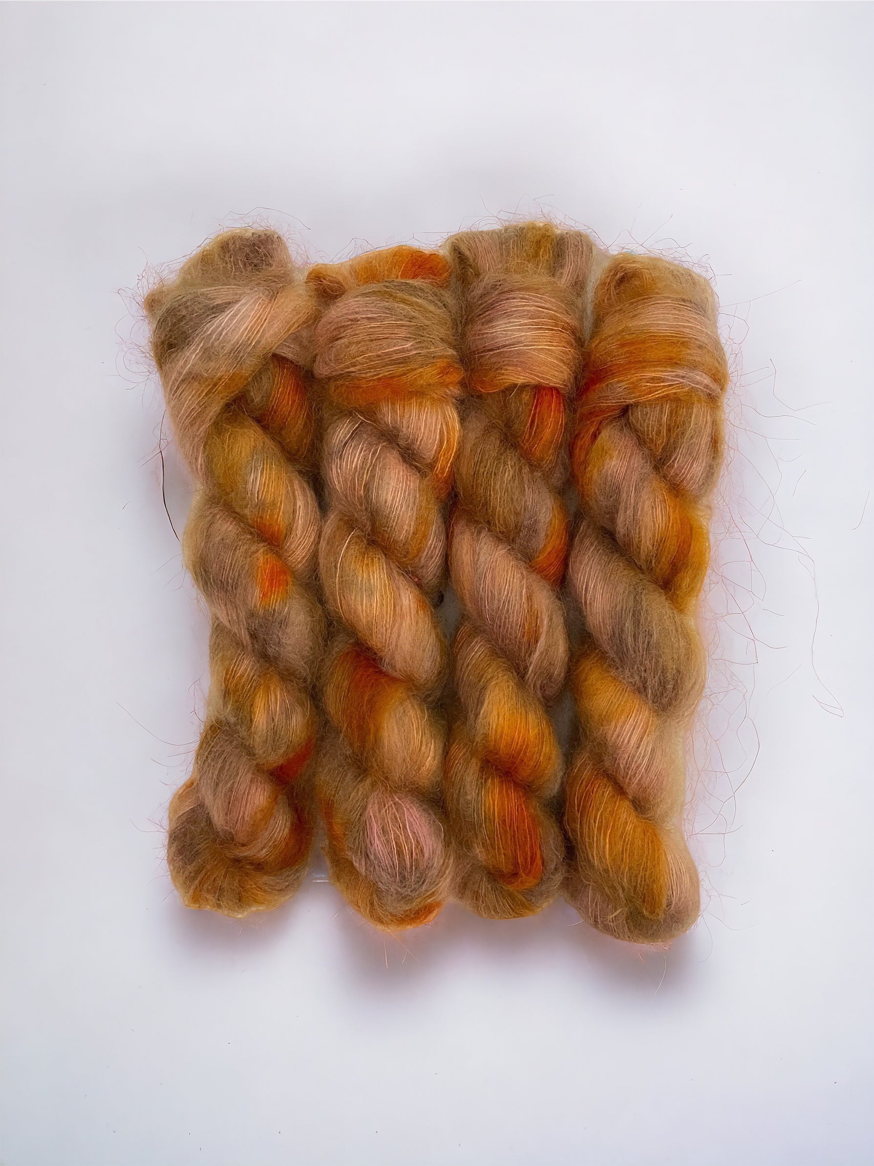  In a delicate lace weight, this 50g skein offers a perfect blend of softness and strength. The rich copper colors add a touch of glamour to your knitting projects.