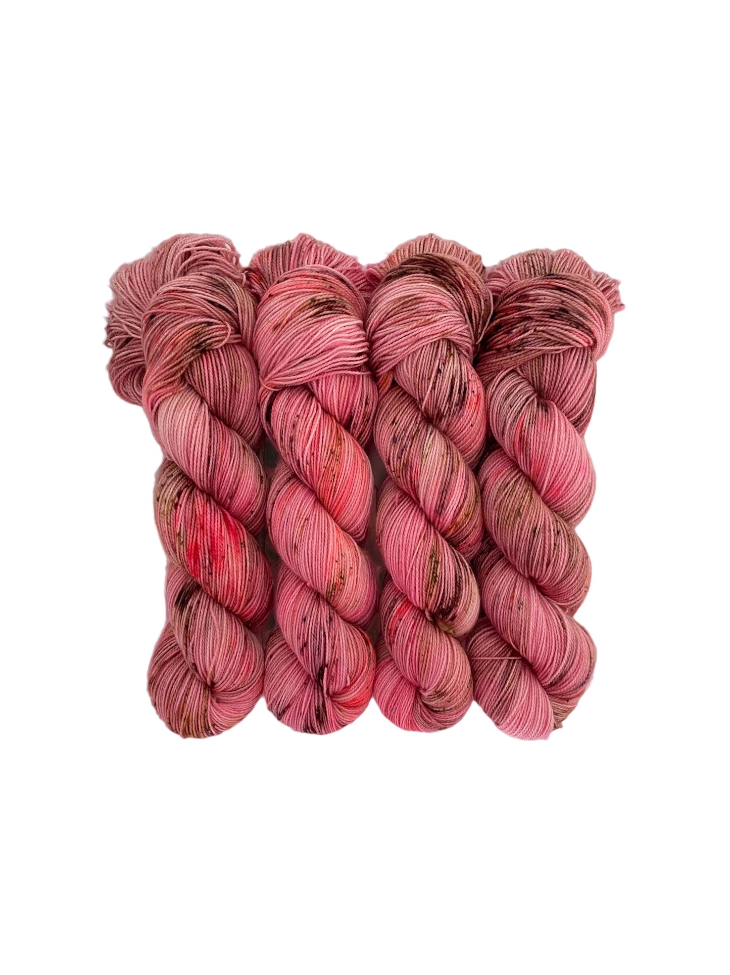 Expertly hand-dyed yarn, in shades of pink, coral, green, and brown speckles. Create unique and vibrant projects with this high-quality yarn. Perfect for knitting, crocheting, and crafting.