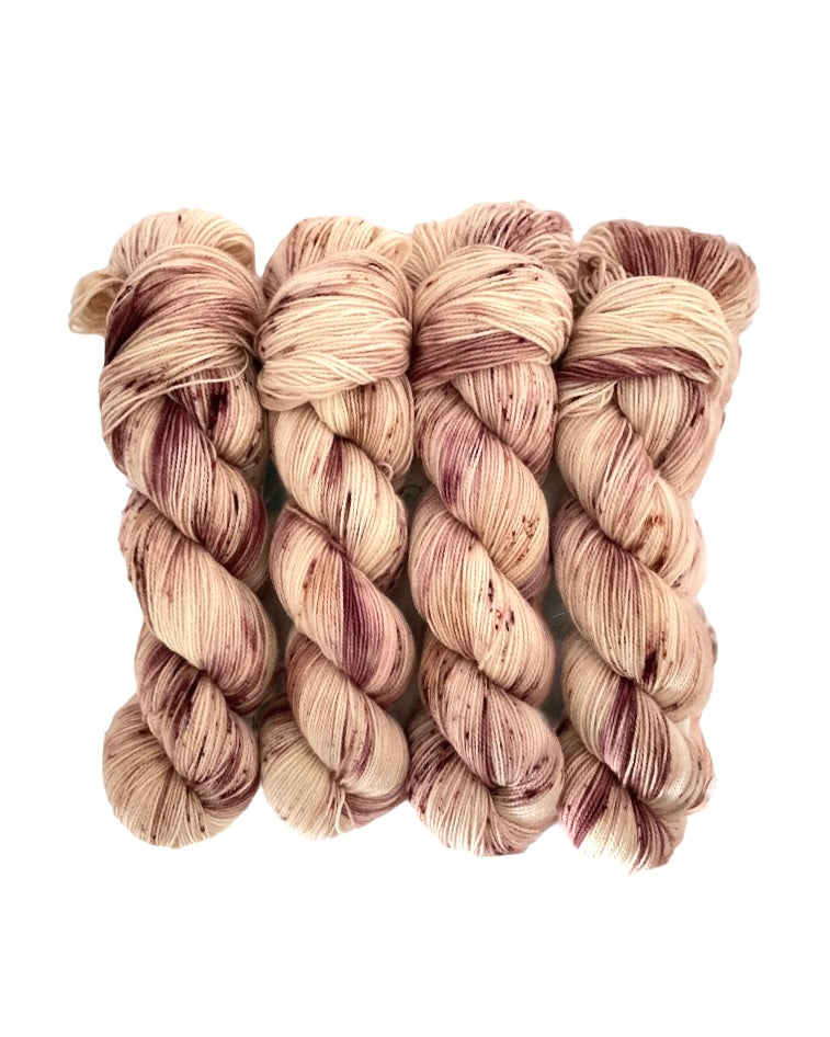 RASPBERRY CREAM yarn is made from 80% Superwash British Blue Faced Leicester wool for a soft, luxurious feel. The addition of 20% nylon adds durability and strength, making it perfect for socks and other projects. Available in a 100g skein in a beautiful palette of cream, brown, and plum.