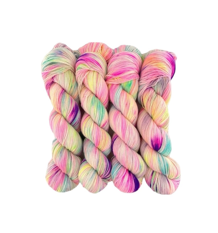 Hand dyed, this fingering/sock weight yarn is made from a luxurious blend of merino wool and nylon. Each 100g skein is uniquely vibrant and soft to the touch. Perfect for creating long-lasting, colorful projects.