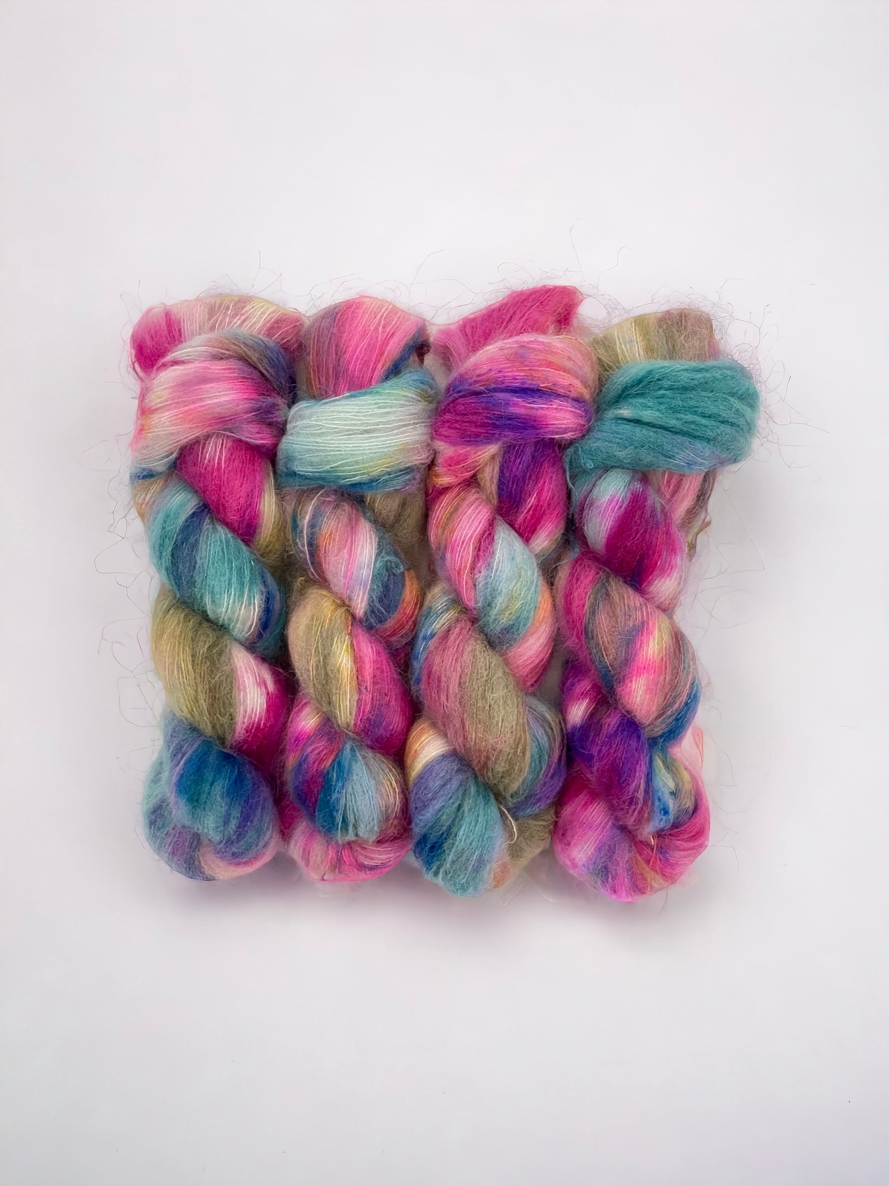 Hand Dyed Yarn.  65%  Baby Suri Alpaca.  35% Mulberry Silk.  Lace Weight.Experience ultimate softness with our hand-dyed suri alpaca and silk blend in beautiful shades of pink, green, and blue.