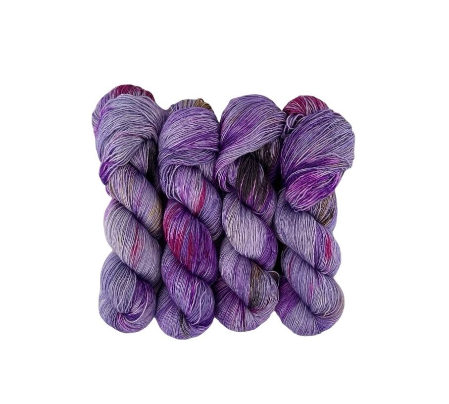 Experience the luxurious softness of hand-dyed single-ply yarn made from a luxurious blend of merino wool and silk. The delicate purple, pink, grey, and gold color combination will add a touch of elegance to your projects. Perfect for knitting or crocheting a one-of-a-kind piece for your next first date.