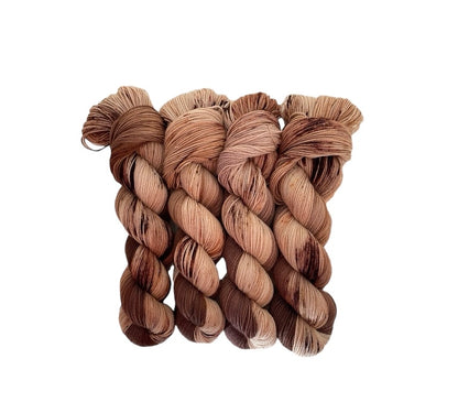 Handcrafted with care and expertise, our DOUBLE CHOCOLATE hand dyed yarn boasts a rich blend of British Blue Faced Leicester wool and nylon. This fingering/sock weight yarn offers both durability and softness, making it perfect for a wide range of projects. The brown and beige hues add depth and dimension to any design.