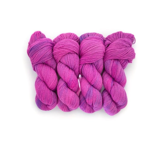 Made from 100% sustainable Merino wool, this fingering knit weight yarn is perfect for eco-conscious knitters looking for high-quality, unique yarn. Each 100g skein is carefully hand-dyed in pinks &amp; purples for a one-of-a-kind result.