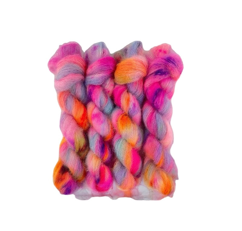 HAPPY ENDINGS hand-dyed yarn is a blend of kid mohair and silk, creating a soft and lightweight texture. The beautiful colors of purple, pink & orange will add a unique touch to your knitting projects. Each 50g skein is carefully crafted for a truly one-of-a-kind piece.