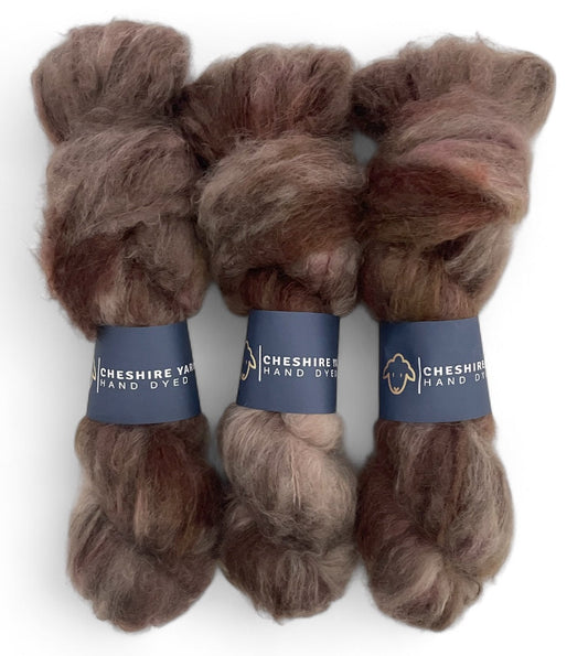 Three skeins of DK weight mohair yarn, hand dyed in shades of brown.